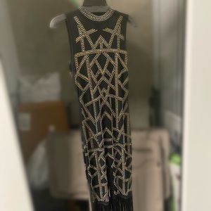 Black and gold studded jumpsuit with fringe bottom